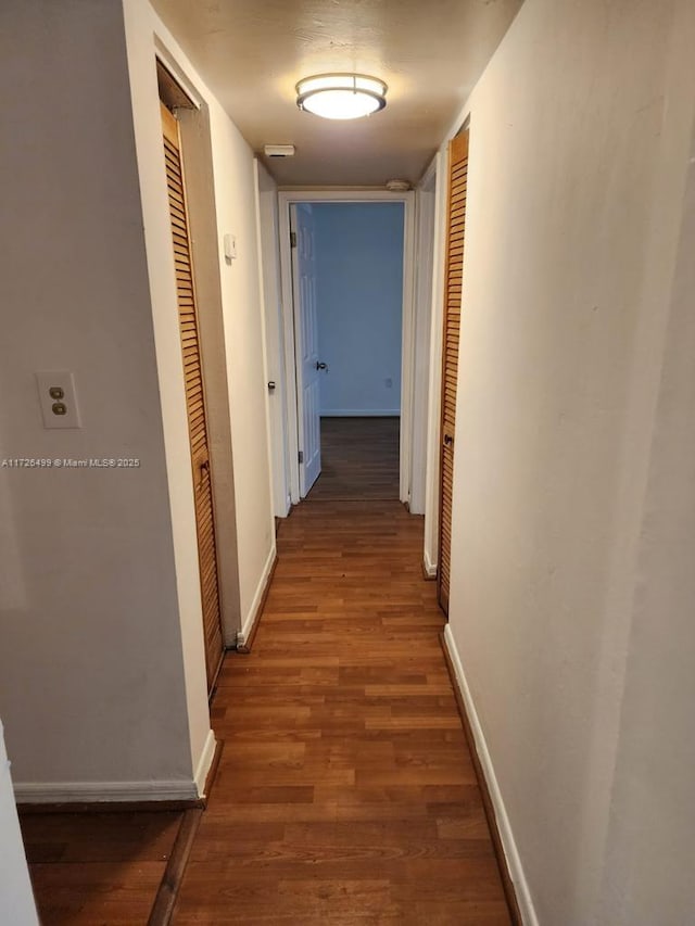 hall with dark hardwood / wood-style flooring