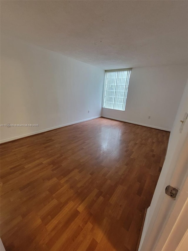 empty room featuring hardwood / wood-style flooring