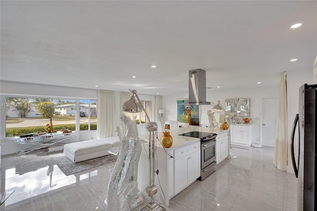 kitchen featuring stainless steel electric range oven, black refrigerator, island exhaust hood, light stone countertops, and white cabinets