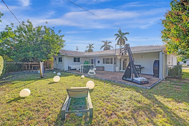 back of house with a yard and a patio area