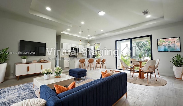 living room with a tray ceiling