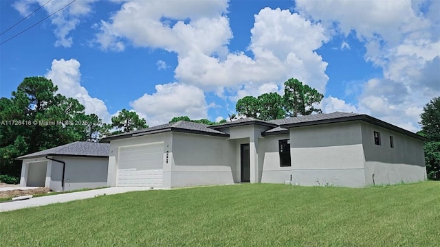 view of front of home with a garage and a front lawn