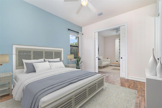 bedroom featuring ceiling fan and light hardwood / wood-style floors