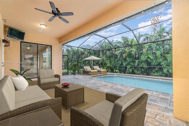 view of pool featuring a lanai, an outdoor hangout area, ceiling fan, and a patio area