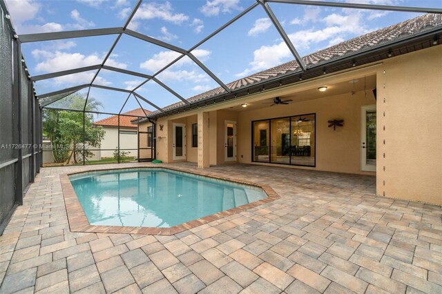 view of pool with ceiling fan, a lanai, and a patio area