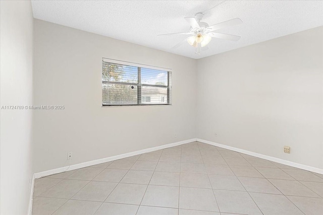 unfurnished room with ceiling fan, a textured ceiling, and light tile patterned floors