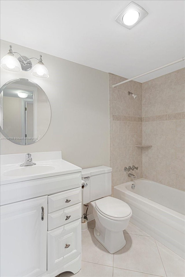 full bathroom featuring toilet, tile patterned flooring, vanity, and tiled shower / bath