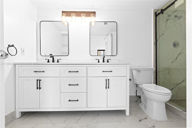 bathroom featuring toilet, a shower with shower door, and vanity