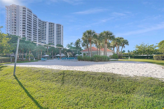 surrounding community featuring volleyball court and a yard