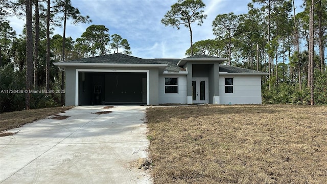 view of front of house with a front yard and a garage