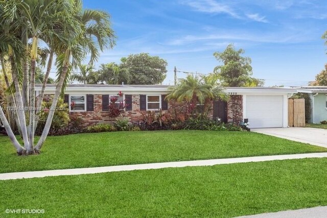 ranch-style home featuring a front yard and a garage