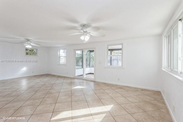 spare room with light tile patterned floors and ceiling fan