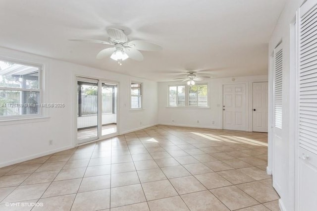 tiled spare room featuring ceiling fan