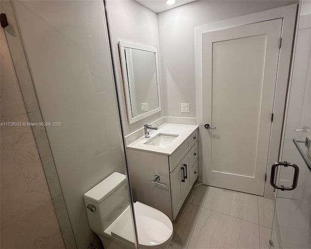 bathroom featuring toilet, tile patterned flooring, and vanity