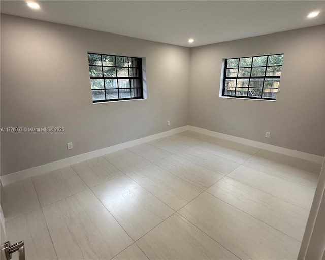 unfurnished room featuring a wealth of natural light