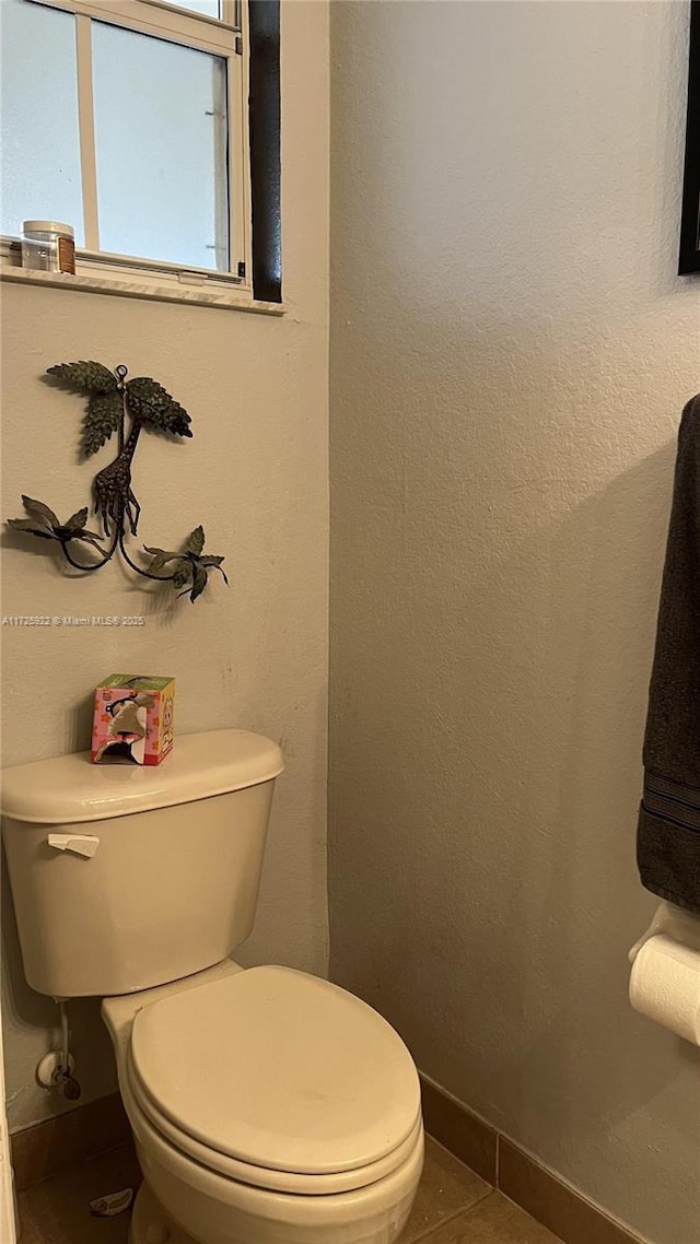 bathroom featuring tile patterned floors and toilet