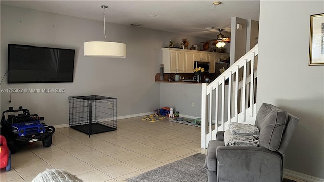 tiled living room with ceiling fan