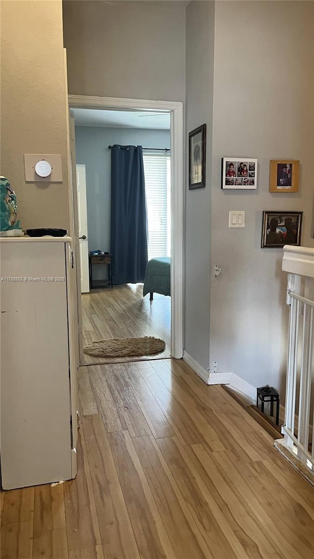 hall with light hardwood / wood-style floors