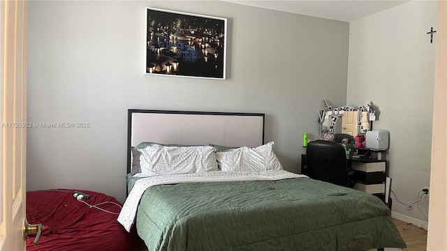 bedroom with hardwood / wood-style flooring