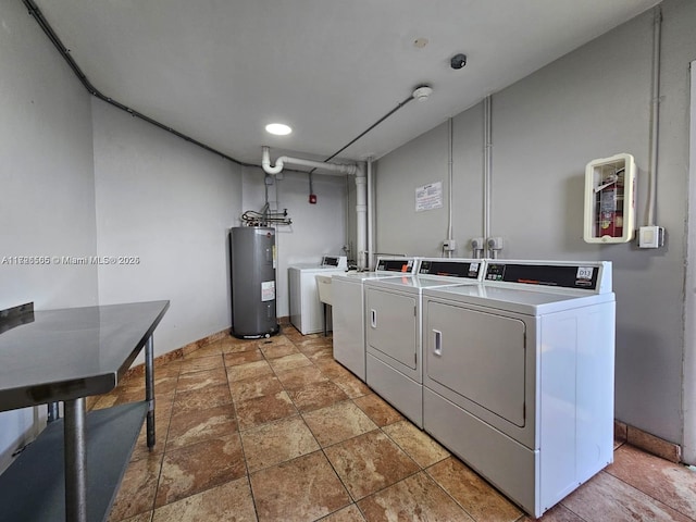 laundry area with washer and clothes dryer and electric water heater