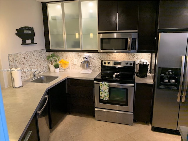 kitchen featuring appliances with stainless steel finishes, backsplash, sink, and light tile patterned floors