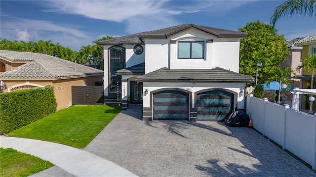 view of front of property featuring a front yard and a garage