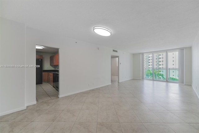 tiled spare room with expansive windows