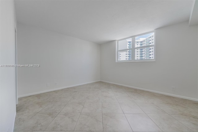 unfurnished room with light tile patterned floors