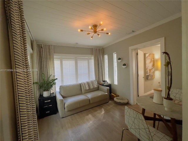 living room with wood finished floors, visible vents, crown molding, and an inviting chandelier