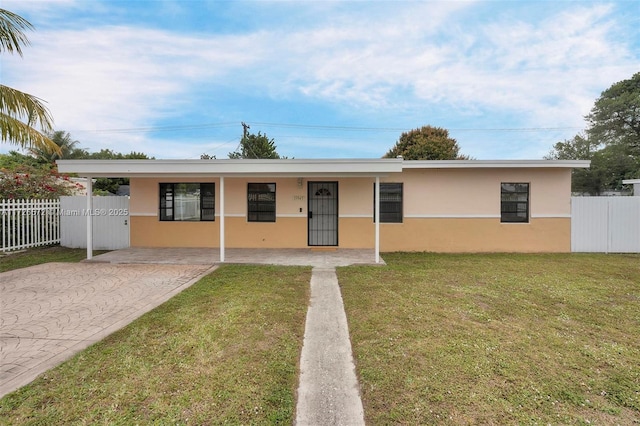 ranch-style house featuring a front yard and a carport