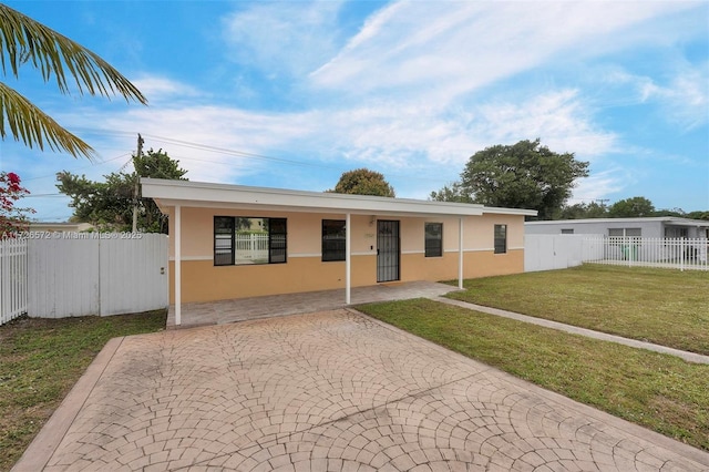 view of front facade with a carport and a front lawn