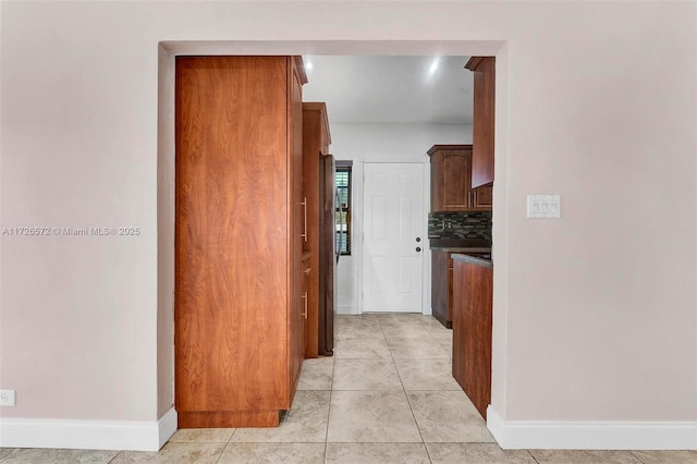 corridor featuring light tile patterned floors