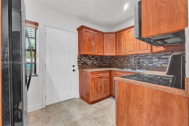 kitchen with light tile patterned floors, backsplash, and sink