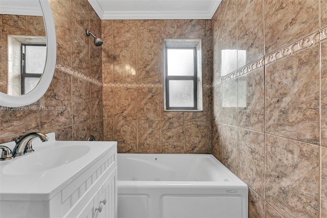 bathroom featuring tile walls, tiled shower / bath, crown molding, and vanity