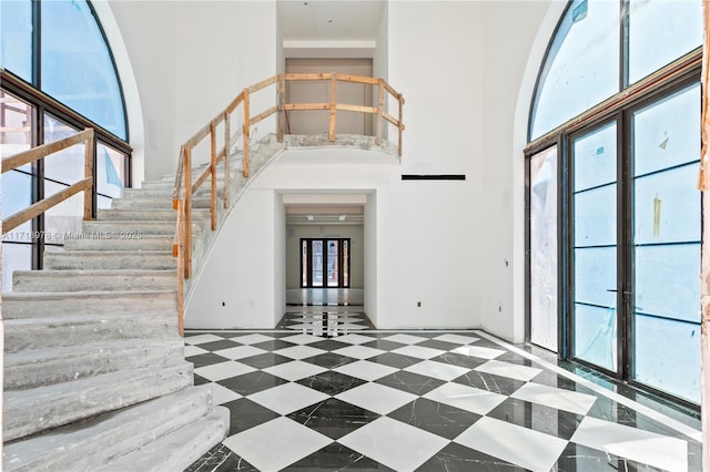 entryway with a high ceiling and stairway