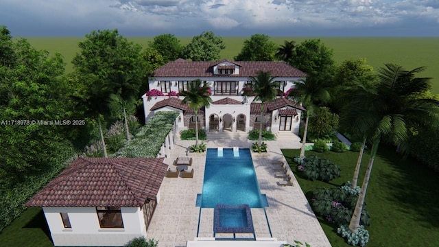 rear view of house with a balcony, a swimming pool with hot tub, and a patio