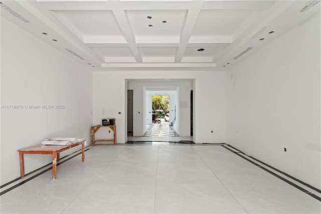 spare room with coffered ceiling and beamed ceiling