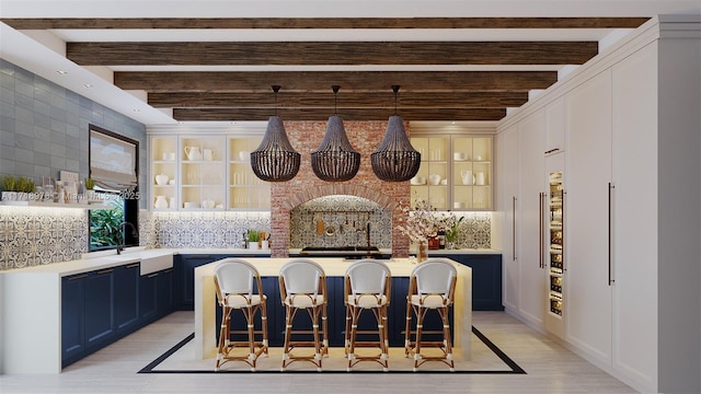 bar featuring sink, decorative backsplash, blue cabinetry, hanging light fixtures, and beam ceiling