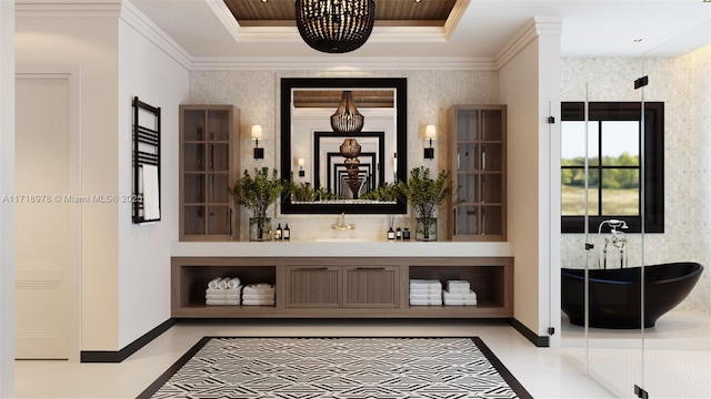 bar with sink, pendant lighting, crown molding, and a tray ceiling