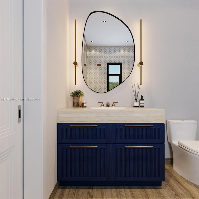 bathroom featuring toilet and vanity