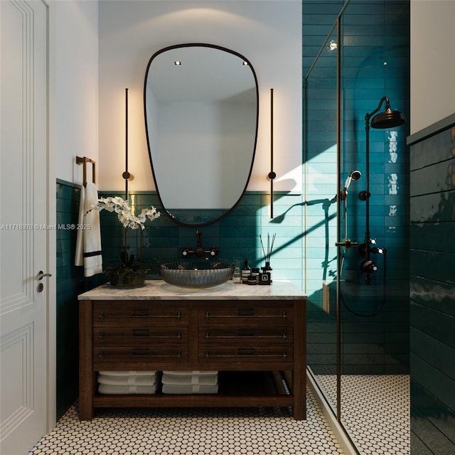 bathroom with tiled shower and vanity