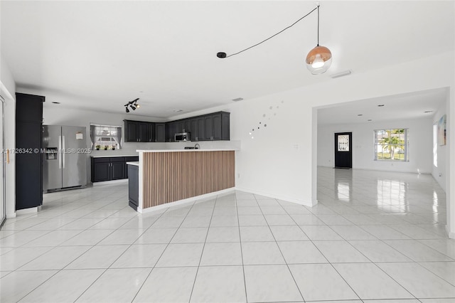 kitchen with stainless steel appliances and light tile patterned floors