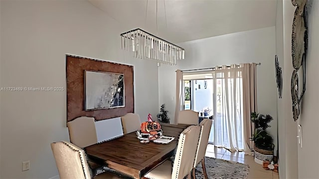 tiled dining area featuring a notable chandelier