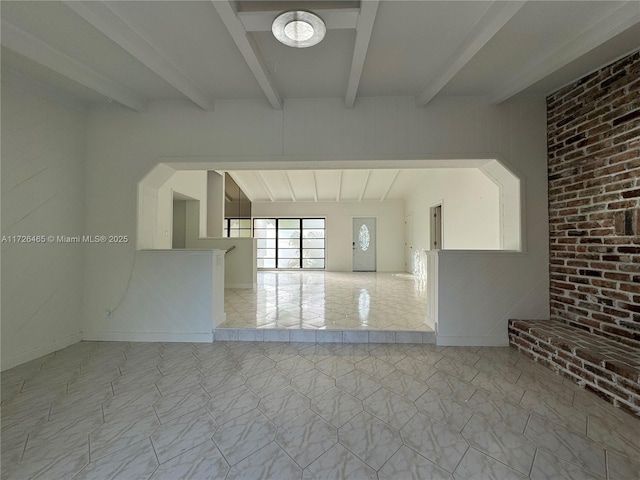 unfurnished room with brick wall, light tile patterned floors, and beamed ceiling