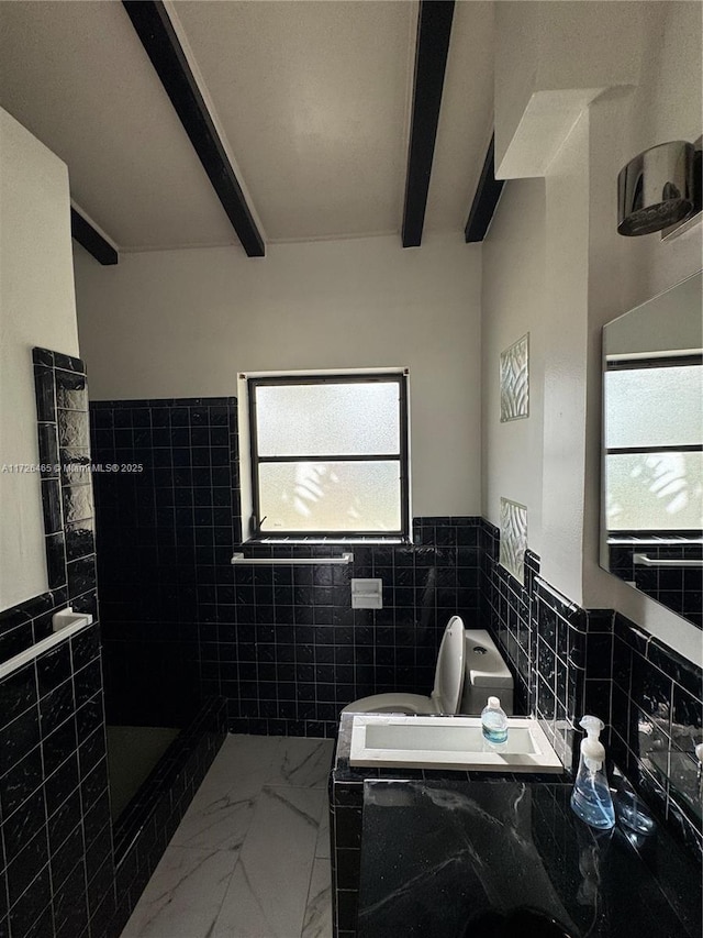 bathroom featuring toilet, tile walls, and beam ceiling