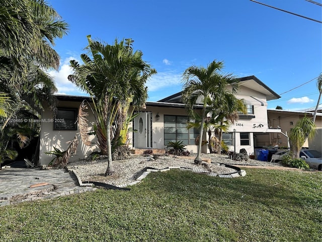 back of house featuring a lawn