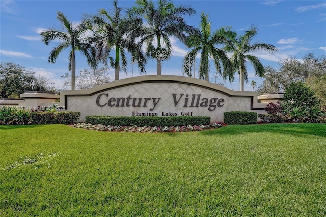 community sign featuring a yard