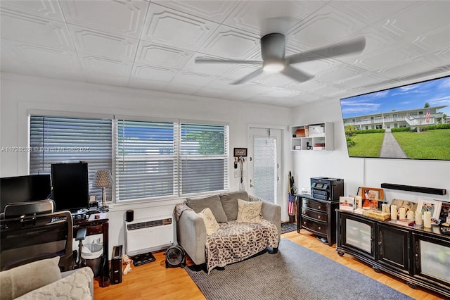 living room featuring light hardwood / wood-style floors and ceiling fan