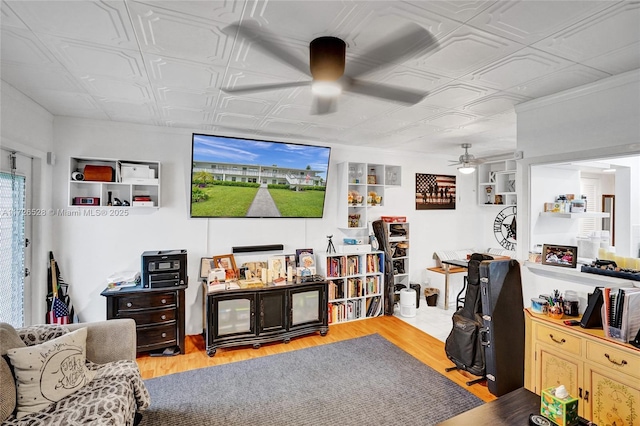 living room featuring ceiling fan and light hardwood / wood-style floors