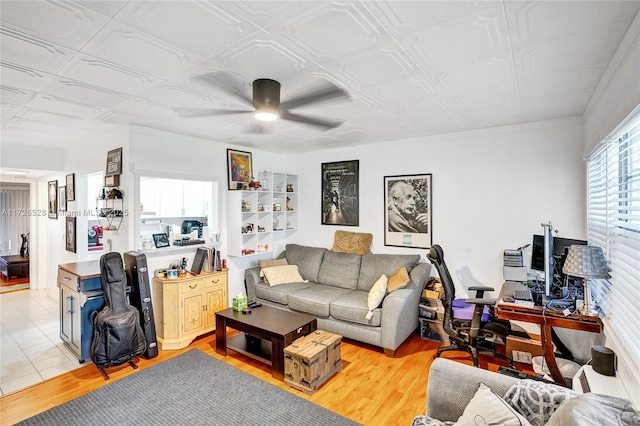 living room with ceiling fan and light hardwood / wood-style floors